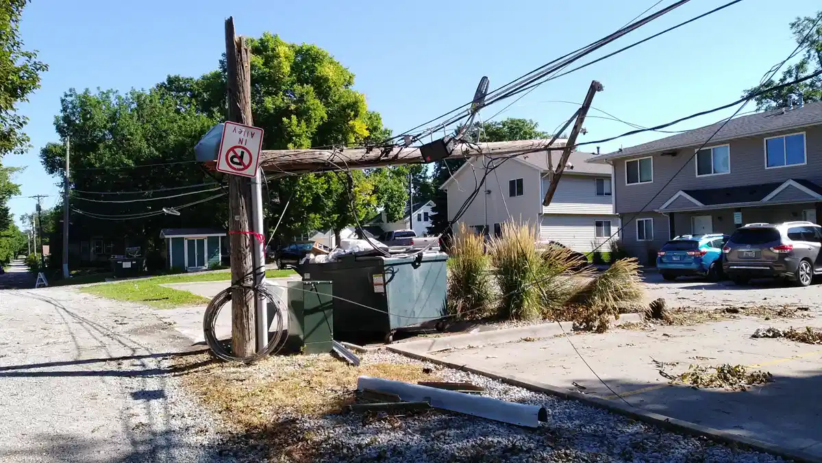power pole broken in half with power lines still attached