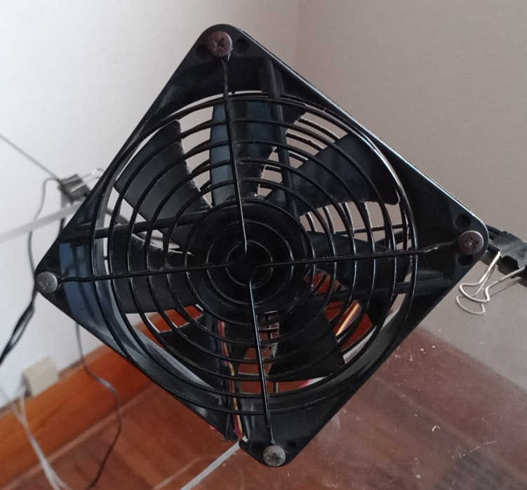 computer case fan mounted on edge of desktop
