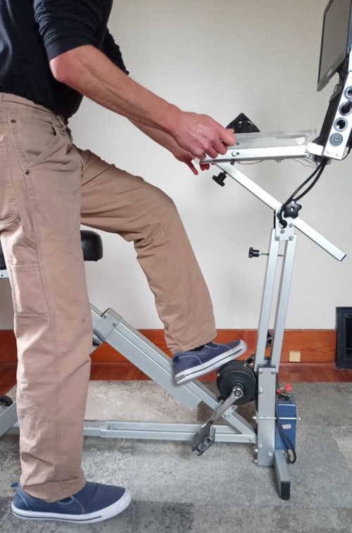 desk pivoted forward and user stepping over the generator prior to using it