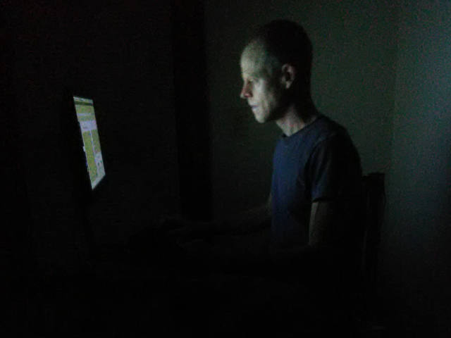 user working at desk in the dark